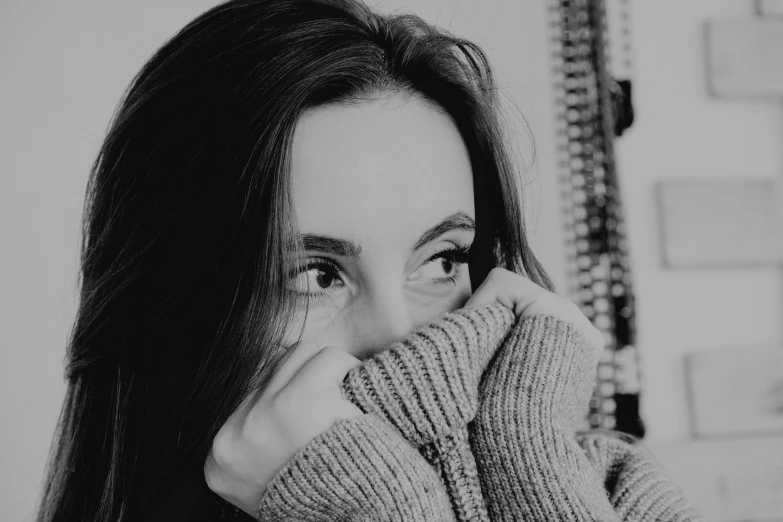 a black and white photo of a woman covering her face, a black and white photo, wearing sweater, beautiful eyes medium shot, thinking pose, instagram post