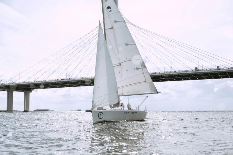 a sailboat in the water with a bridge in the background, skybridges, grey, lightweight, tournament