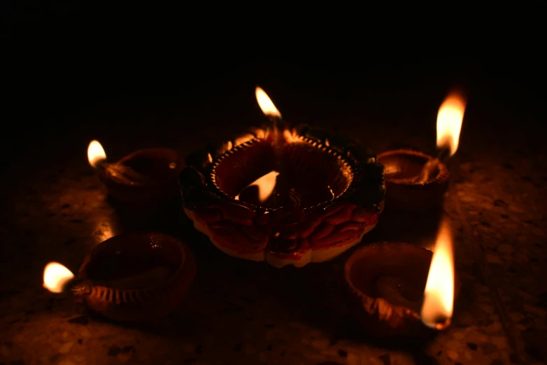 a group of lit candles sitting on top of a table, by Jessie Algie, hurufiyya, hindu ornaments, flares, single light, image