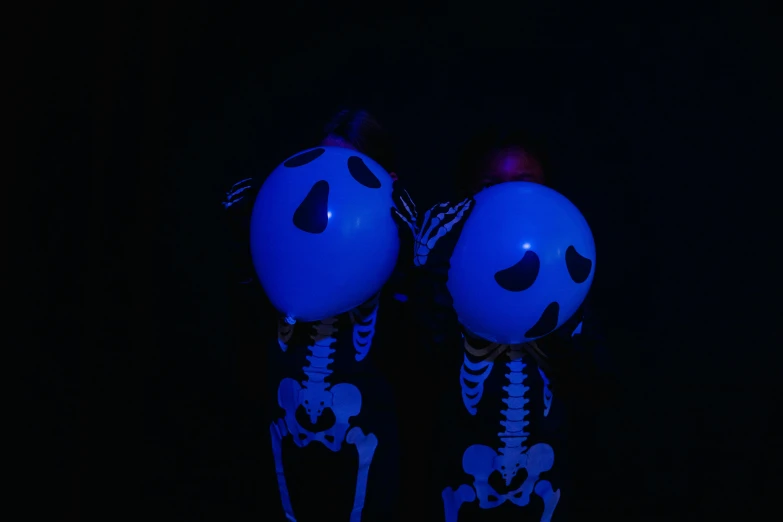 a couple of balloons sitting next to each other, an album cover, unsplash, vanitas, blue glowing eyes, ( ( ( skeleton ) ) ), profile picture 1024px, bottom - view