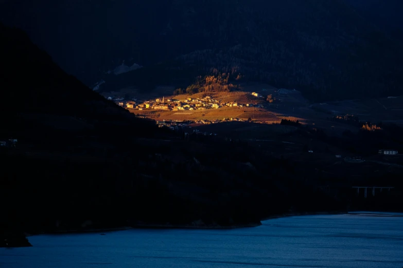 a large body of water with a mountain in the background, by Tobias Stimmer, pexels contest winner, renaissance, nightime village background, telephoto photography, late afternoon light, led