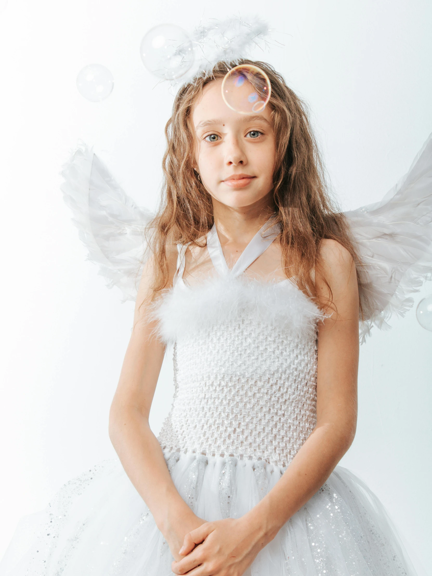 a little girl dressed up as an angel, pexels contest winner, on the white background, teen elf girl, style of julia razumova, wearing a dress made of beads