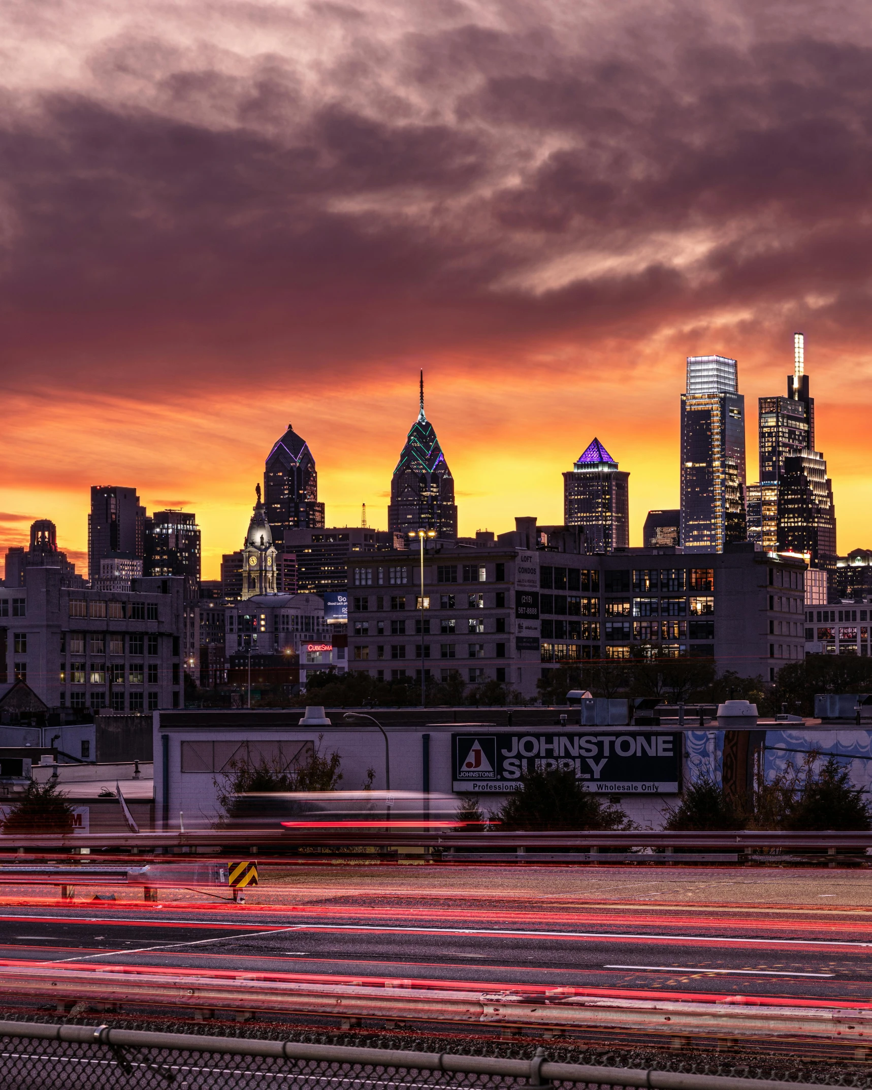 a view of a city skyline at sunset, by Jacob Burck, unsplash contest winner, always sunny in philadelphia, lgbtq, tourist photo, red lights