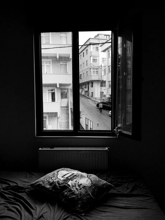 a black and white photo of a bed in a dark room, a black and white photo, by Niyazi Selimoglu, view from window on megapolis, fallout style istanbul, beautiful morning, anna nikonova