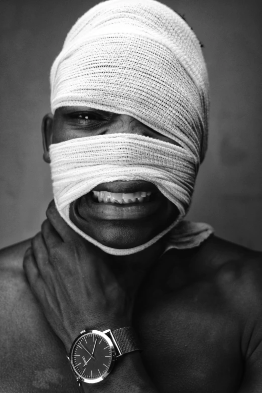 a man with bandages wrapped around his face, an album cover, inspired by Gordon Parks, hyperrealism, happy and disarmed, kano), cedric payravernay, dark and white