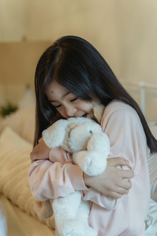 a woman sitting on a bed holding a white teddy bear, people crying, young asian girl, multiple stories, kids