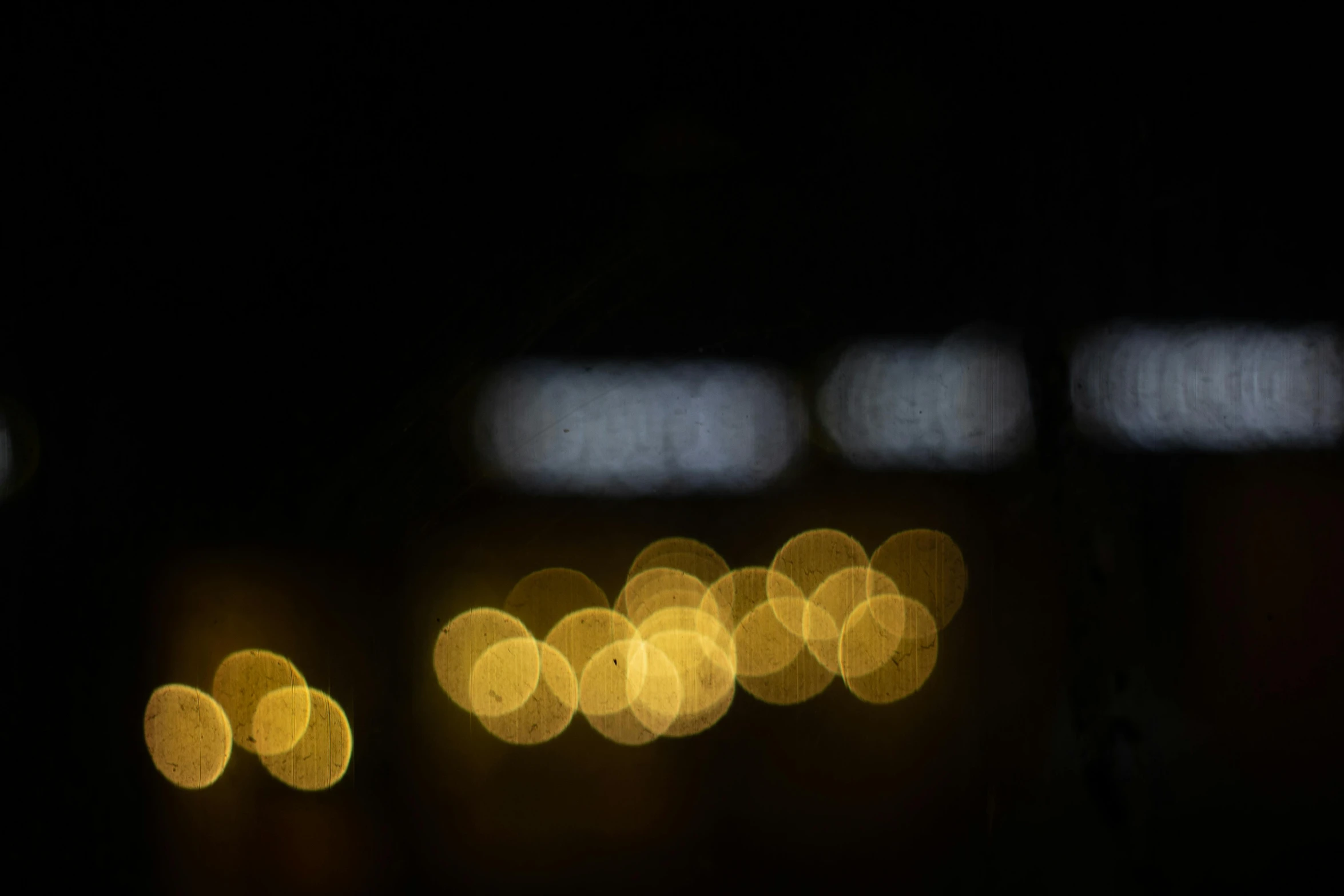 a blurry photo of a street at night, a picture, unsplash, light and space, overcast bokeh - c 5, gold dappled light, soft light - n 9, window lights