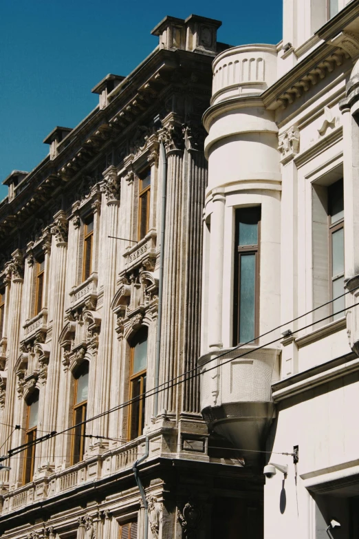 a clock that is on the side of a building, inspired by Mihály Munkácsy, neoclassicism, seen from afar, buildings covered with greebles, 1910s architecture, north melbourne street