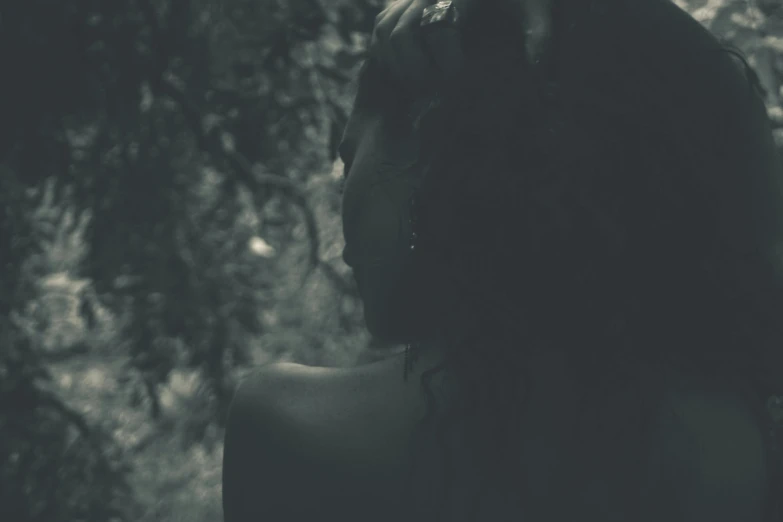 a woman standing in front of a tree, inspired by Elsa Bleda, pexels contest winner, tonalism, portrait of a dark fantasy nymph, showing her shoulder from back, carnal ) wet, vintage photo