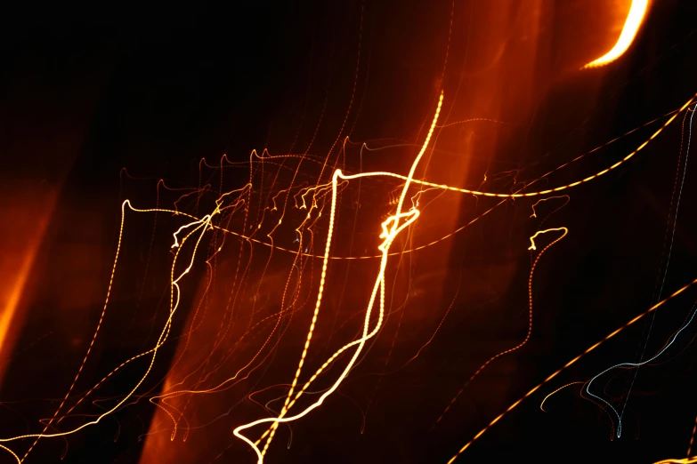 a blurry photo of a street at night, an album cover, unsplash, lyrical abstraction, orange electricity, ignant, scratchy lines, magical sparks