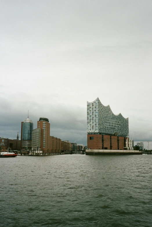 a large body of water with buildings in the background, a photo, inspired by David Chipperfield, port, low dutch angle, 1996), low quality photo