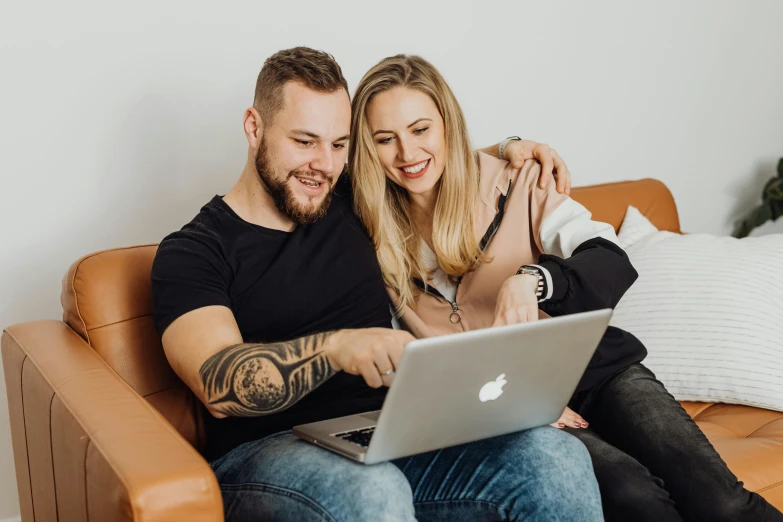 a man and woman sitting on a couch looking at a laptop, pexels contest winner, millaise and greg rutkowski, dating app icon, tattooed, 9 9 designs