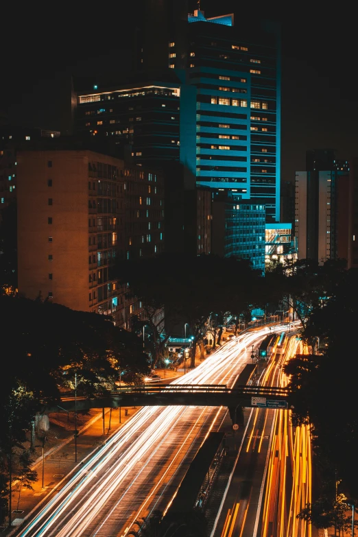 a city street filled with lots of traffic next to tall buildings, by Alejandro Obregón, pexels contest winner, lush tress made of city lights, brazil, gif, infrastructure