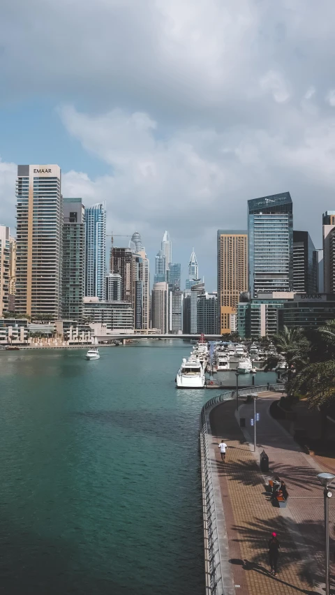 a large body of water surrounded by tall buildings, by Bernardino Mei, pexels contest winner, hurufiyya, middle eastern, harbour in background, low quality photo, video footage