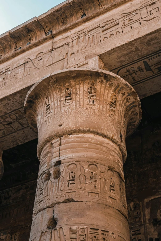 a close up of a pillar with a sky in the background, egyptian art, by Daniel Lieske, pexels contest winner, etched inscriptions, brown, close-up from above, inside her temple