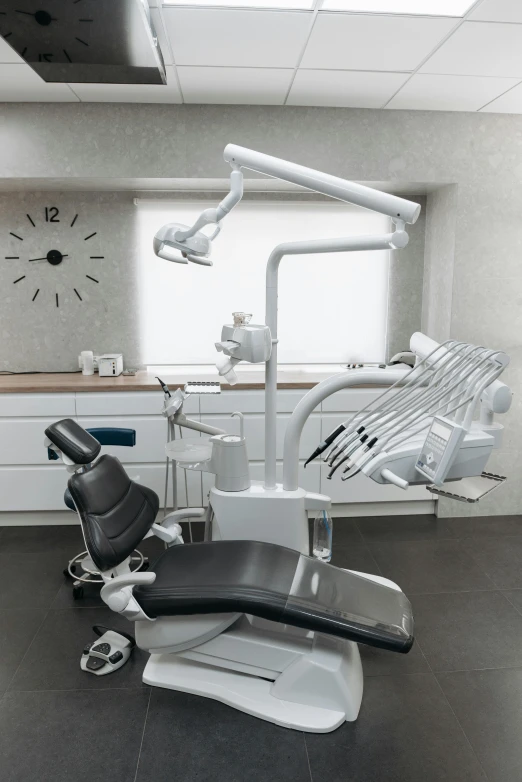 a dentist's chair in the middle of a room, by Daarken, on grey background, titanium white, lifestyle, (night)