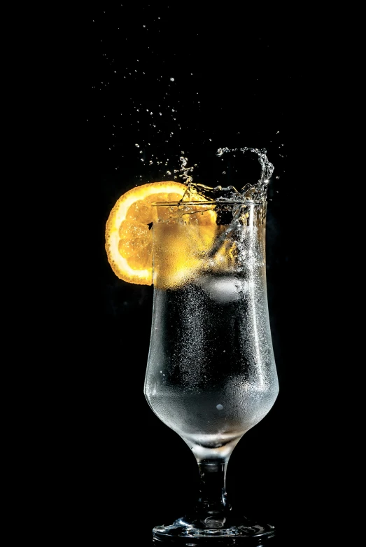 a glass of water with a slice of lemon in it, by Jan Rustem, pexels, photorealism, bubbles in the air, an orange, charcoal and champagne, dramatic product shot