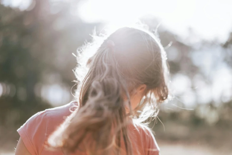 a little girl standing in a field with a frisbee, by Emma Andijewska, trending on unsplash, long ashy hair | gentle lighting, pictured from the shoulders up, warm sunlight shining in, 15081959 21121991 01012000 4k