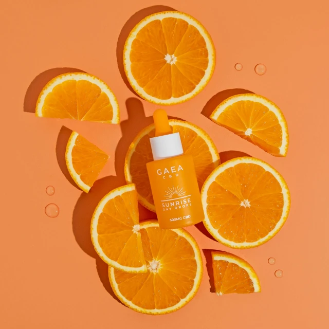 a bottle of orange juice surrounded by slices of oranges, by Olivia Peguero, photoshoot for skincare brand, caza, detailed product image, orange spike aura in motion