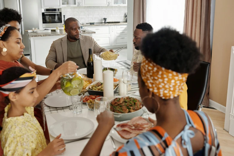 a group of people sitting around a dinner table, black people, caring fatherly wide forehead, profile image, fan favorite