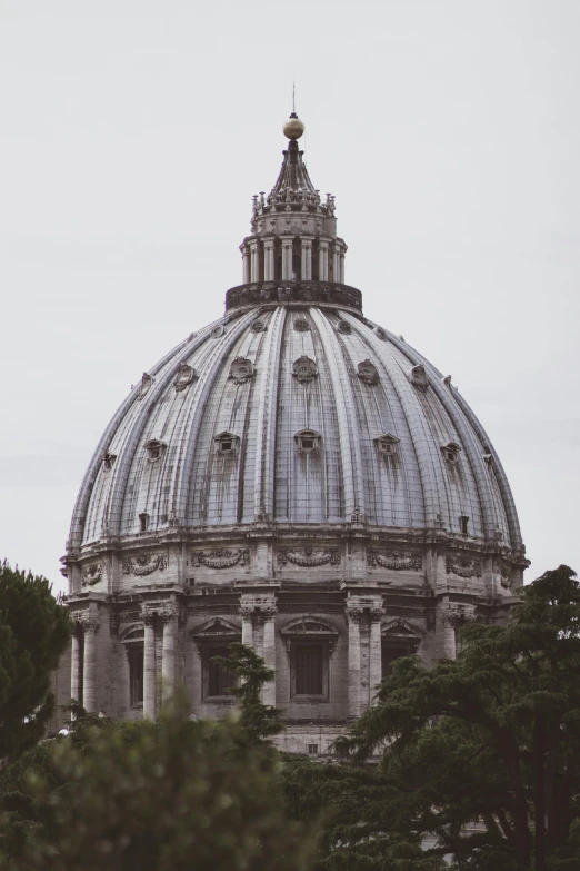 a dome on top of a building surrounded by trees, inspired by Cagnaccio di San Pietro, unsplash contest winner, grey, low quality photo, pope, no watermarks