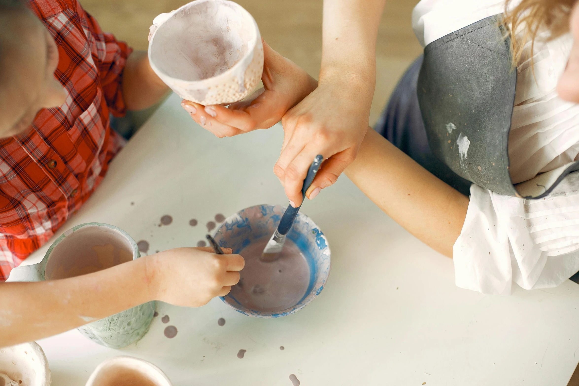 a couple of people that are sitting at a table, trending on pexels, process art, mortar and pestle, children's, brown, paint