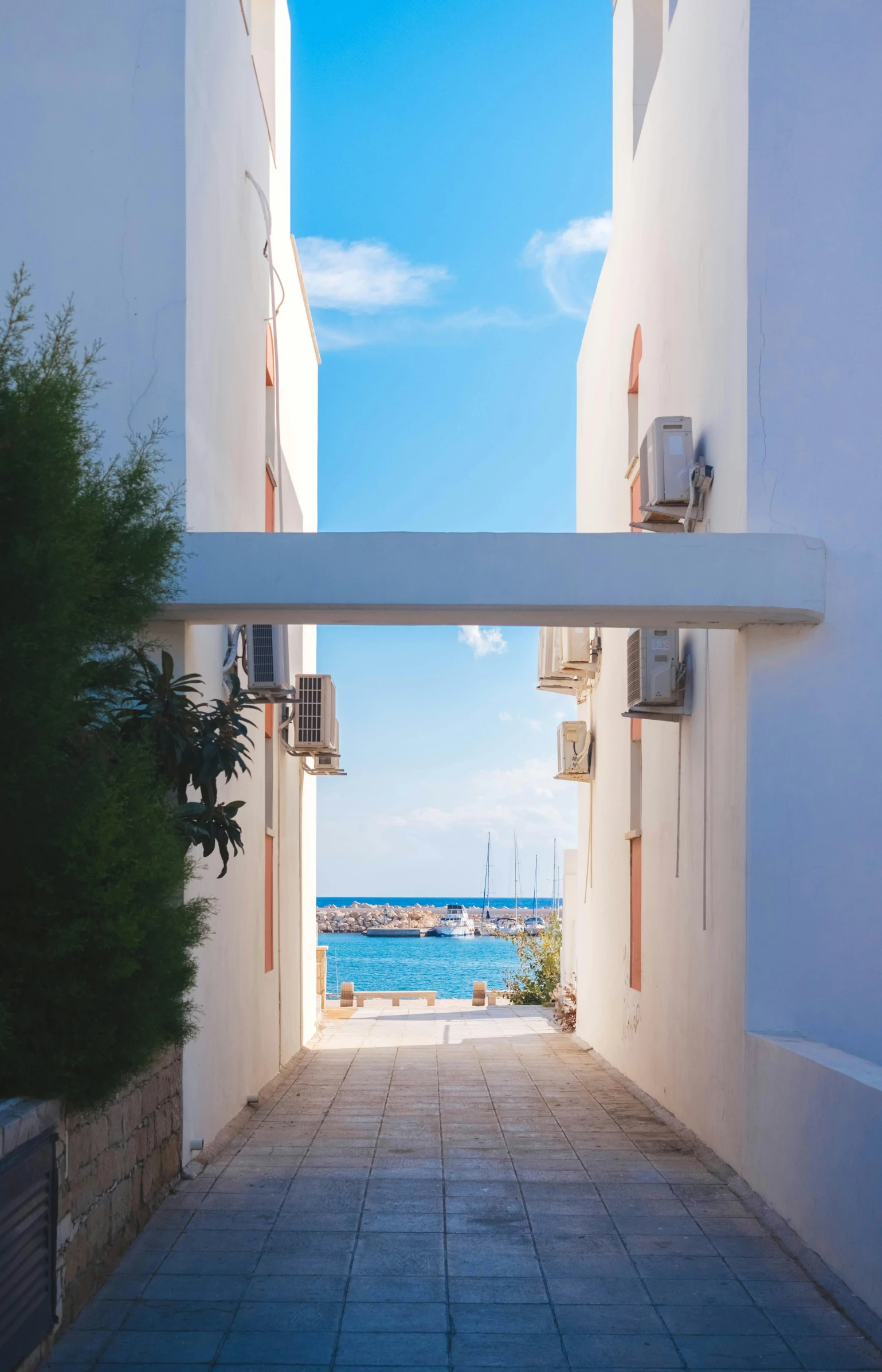 a couple of buildings that are next to each other, a photo, by Constantine Andreou, unsplash, summer street near a beach, doorways, white wall complex, 15081959 21121991 01012000 4k