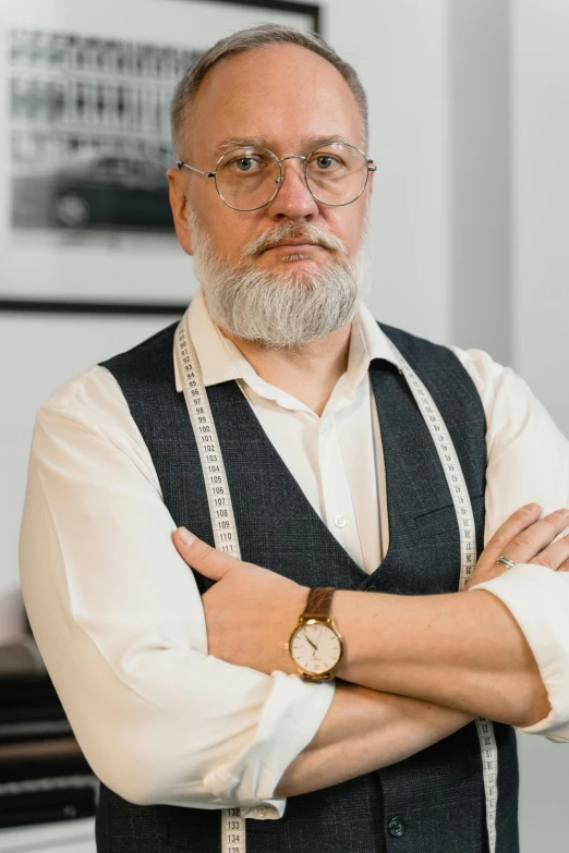 a man standing with his arms crossed in front of a piano, inspired by Lajos Vajda, pexels contest winner, overalls and a white beard, headshot profile picture, fashion designer, wearing a suit and glasses