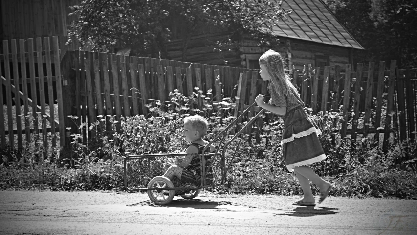 a black and white photo of a woman pushing a child in a stroller, by Marie Bashkirtseff, pixabay, naive art, russian village, boy and girl, square, photo taken on a nikon