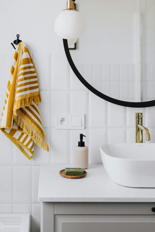 a white sink sitting under a mirror in a bathroom, by Nicolette Macnamara, featured on pinterest, bauhaus, with yellow cloths, close-up product photo, round-cropped, scandinavian design