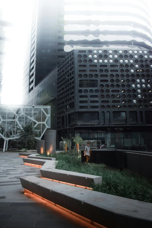 a man riding a skateboard down a sidewalk next to tall buildings, a digital rendering, by Zha Shibiao, unsplash, modernism, brutalist courtyard, lit. 'the cube', mexico city, lush surroundings