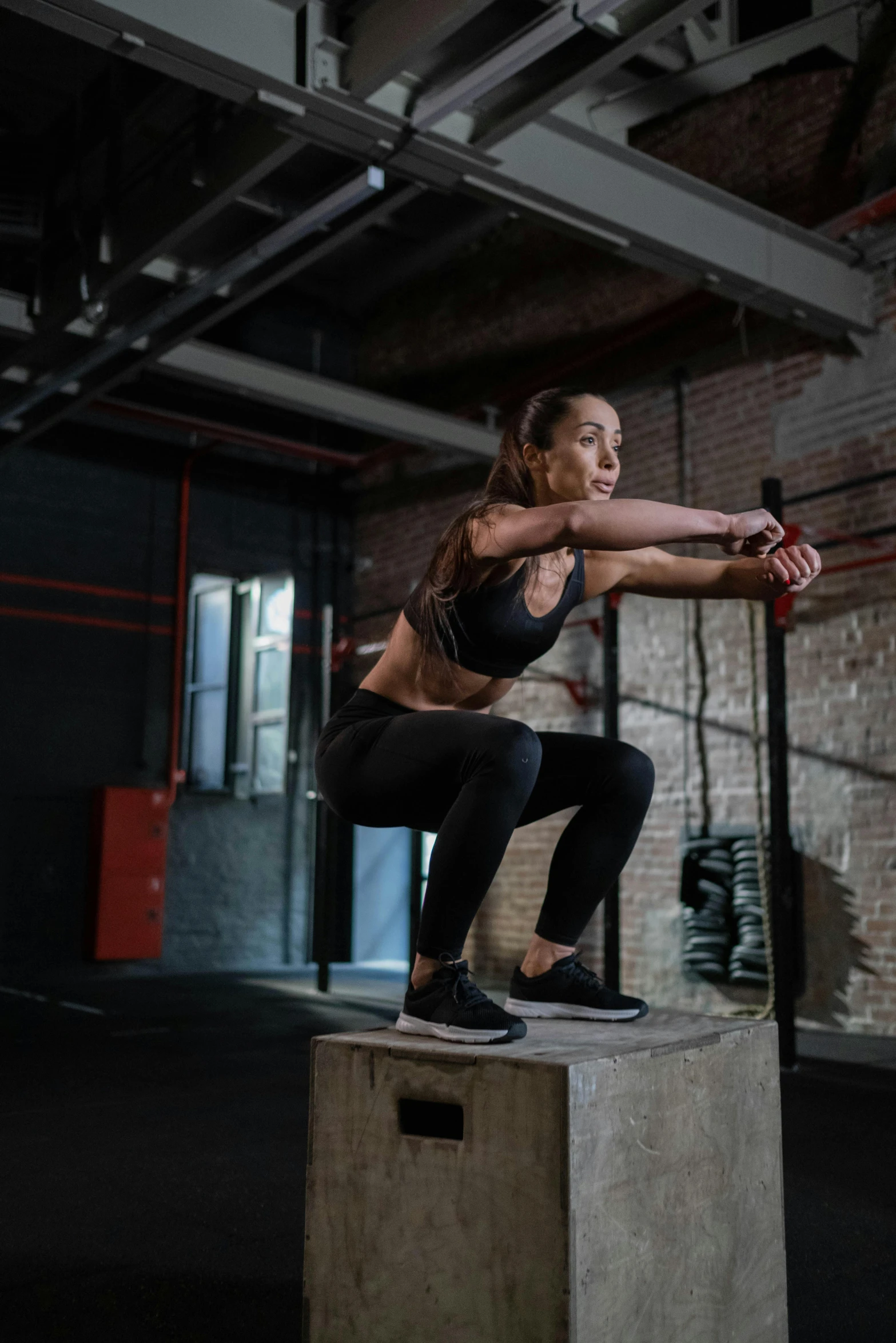 a woman doing a box jump in a gym, a portrait, by Jan Tengnagel, pexels contest winner, profile image, promo image, athletic crossfit build, full body image