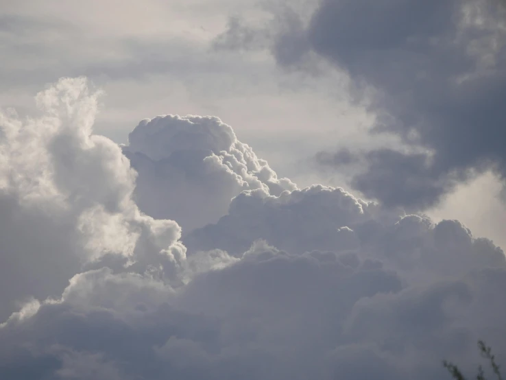 a jetliner flying through a cloudy sky, by Neil Blevins, pexels contest winner, romanticism, cumulus clouds, close - up photograph, grey, cotton candy clouds