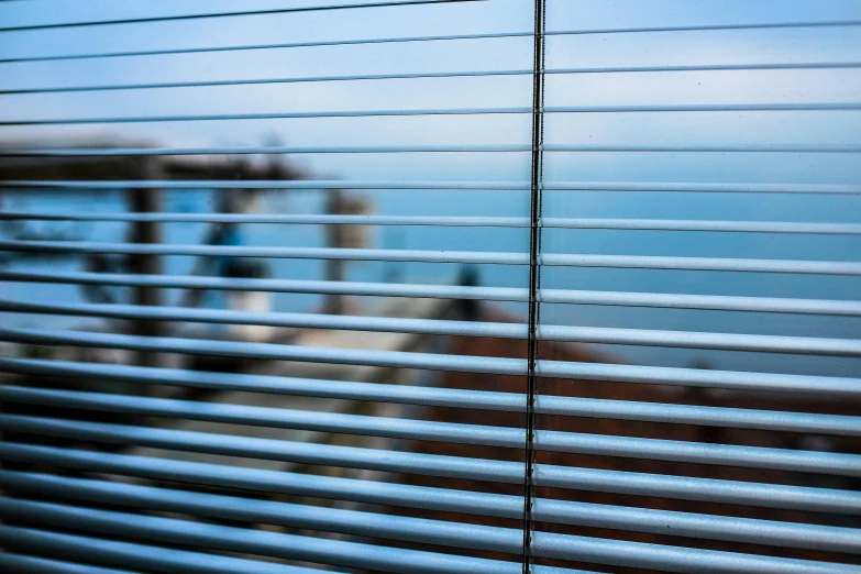 a close up of a window with blinds, a picture, inspired by Andreas Gursky, unsplash, seaview, blue blurred, glass and steel, hdri