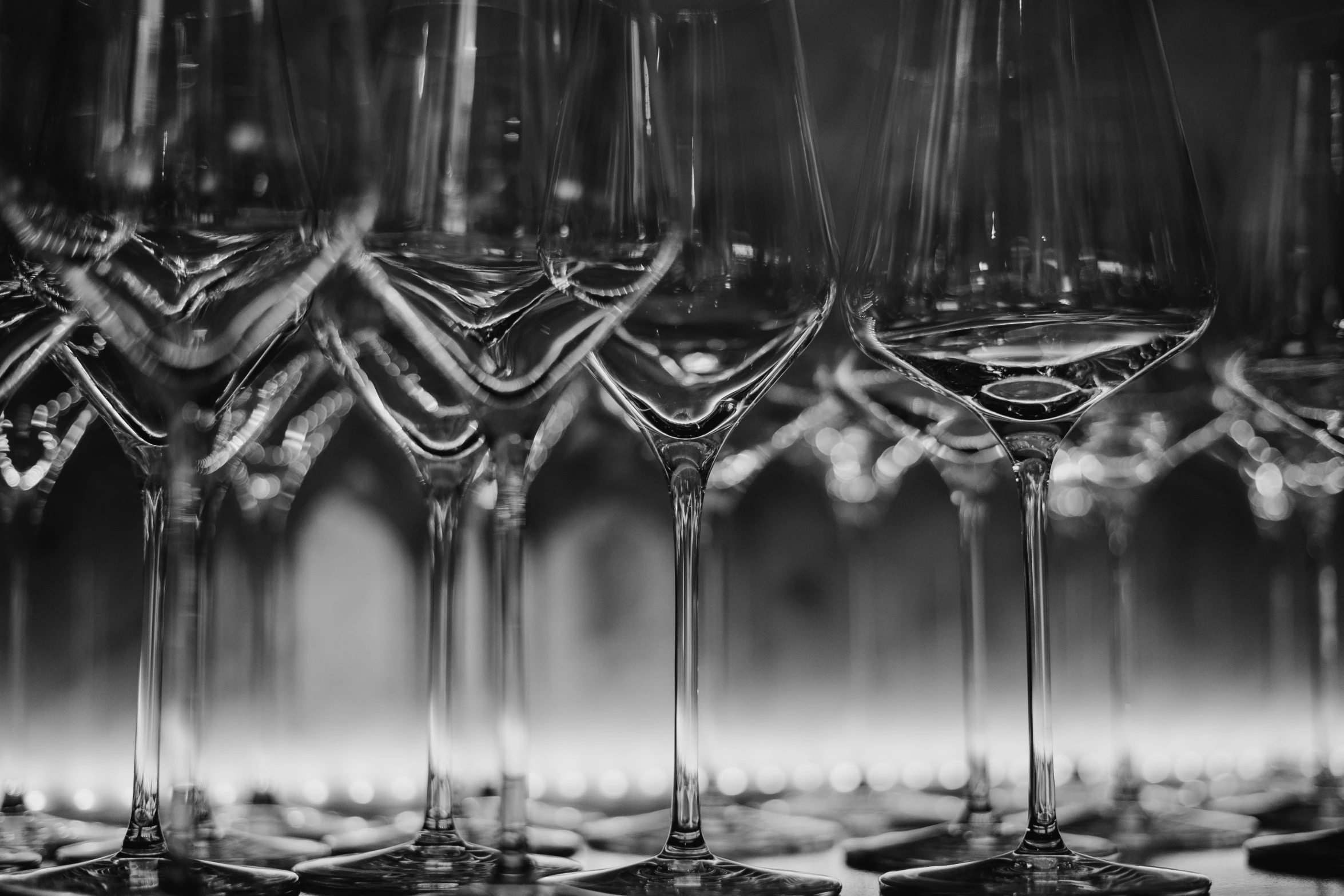 a bunch of wine glasses sitting on top of a table, a black and white photo, pexels, process art, stacked image, made of glass, detail shot, multiple stories