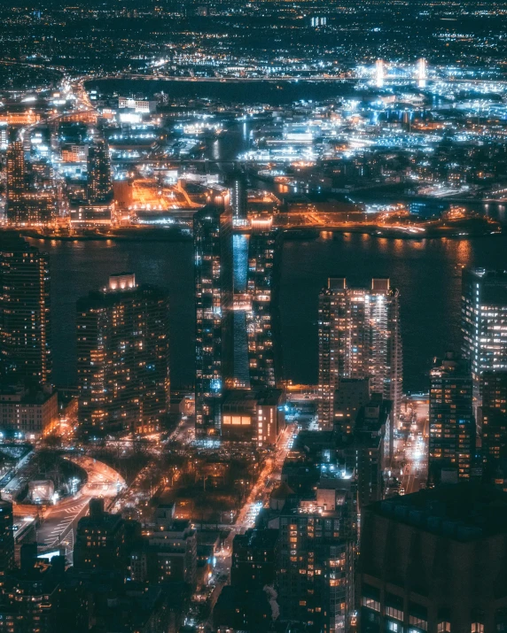 an aerial view of a city at night, pexels contest winner, new jersey, instagram post, stacked city, gif