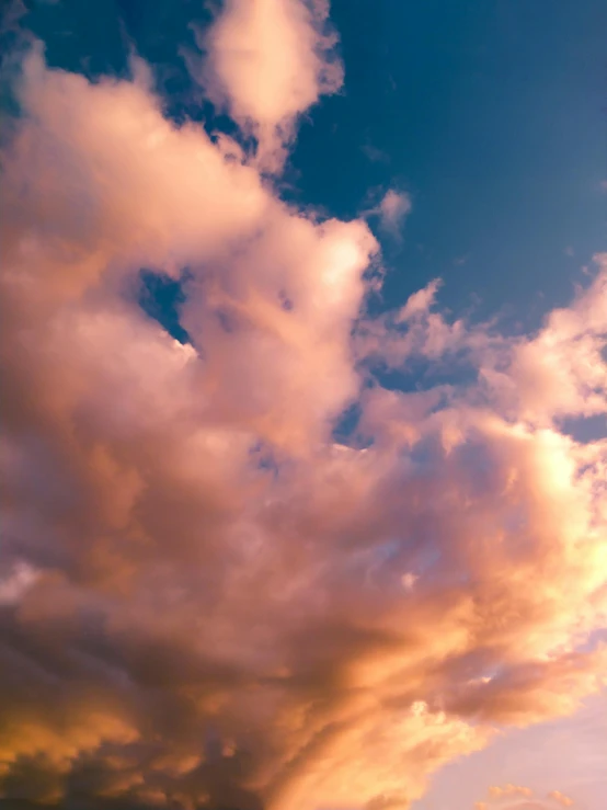 there is a plane that is flying in the sky, by Carey Morris, unsplash, romanticism, shades of aerochrome gold, cumulus, late summer evening, today\'s featured photograph 4k