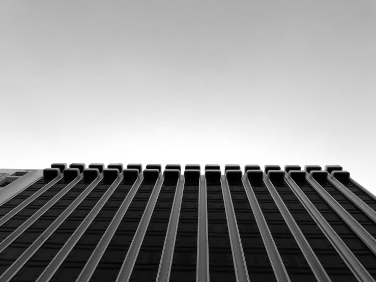 a black and white photo of a tall building, unsplash, minimalism, square lines, sky focus, desktop wallpaper, f/1.8
