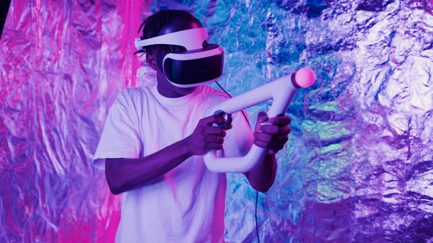 a man in a white shirt holding a water gun, concept art, inspired by David LaChapelle, unsplash, afrofuturism, using a vr headset, gaming room in 2 0 4 0, purple ambient light, futuristic clothing and helmet
