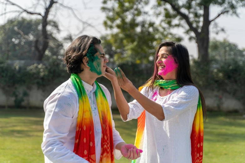 a couple of people that are standing in the grass, pexels contest winner, color field, wearing traditional garb, splashes of colors, white, facial