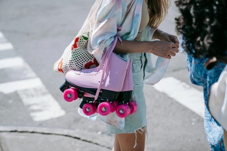 a woman walking down the street carrying a pink skateboard, a colorized photo, by Julia Pishtar, trending on pexels, holding mesh bag with bagels, rollerskaters, sydney sweeney, candy pastel