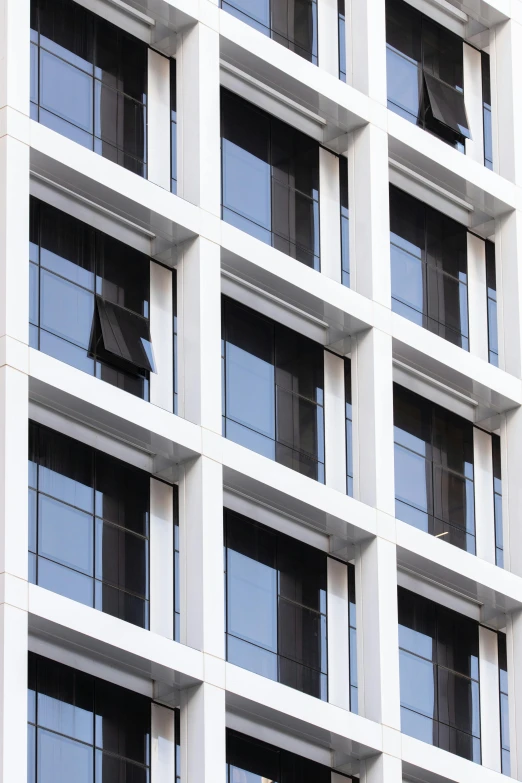 a tall white building with lots of windows, inspired by David Chipperfield, unsplash, steel window mullions, detail shot, arasaka, ignant