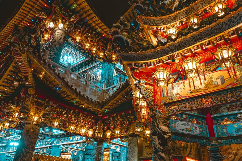 a group of people standing inside of a building, unsplash contest winner, cloisonnism, elaborate carved wood balconies, lights on ceiling, taiwan, mythical shrine