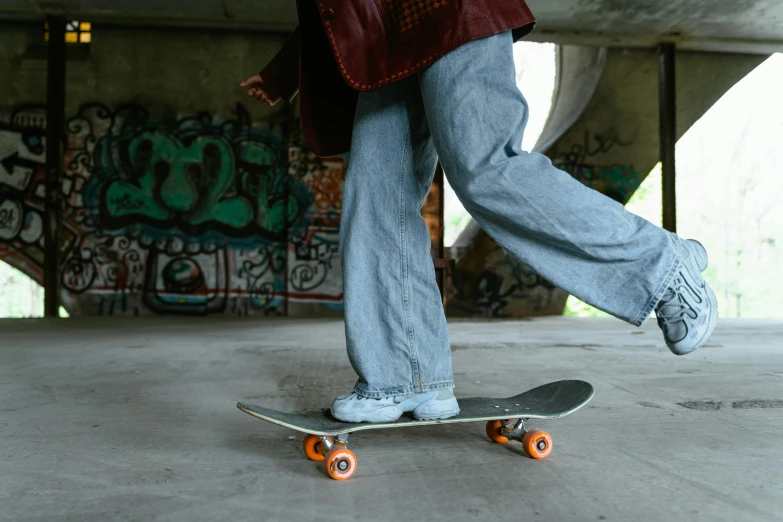 a person riding a skateboard under a bridge, pexels contest winner, grey orange, baggy jeans, at home, 🦩🪐🐞👩🏻🦳