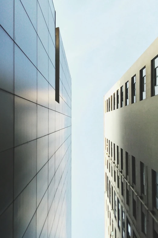 a couple of tall buildings next to each other, a photo, inspired by David Chipperfield, unsplash, face looking skyward, architectural finishes, architectural visualization, looking left