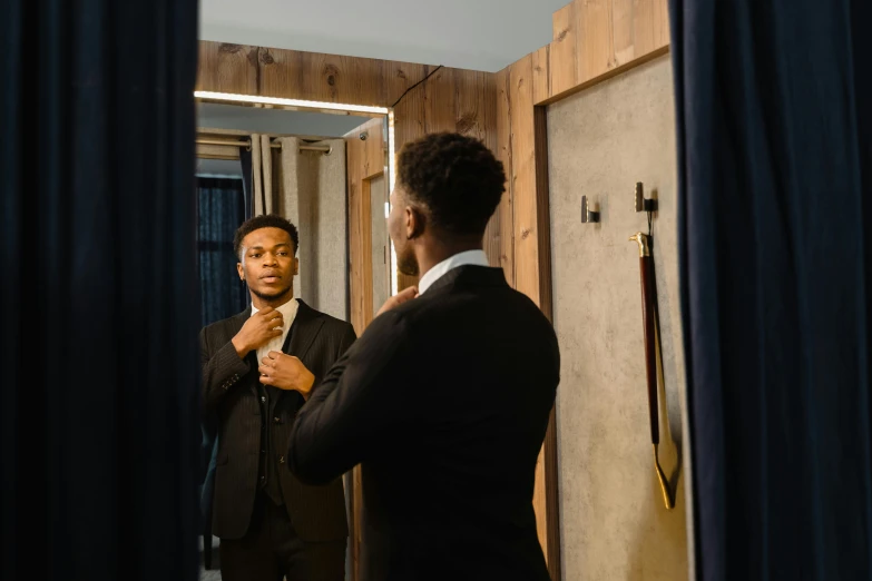 a man adjusting his tie in front of a mirror, pexels contest winner, renaissance, ( ( dark skin ) ), full body model, three piece suit, black teenage boy