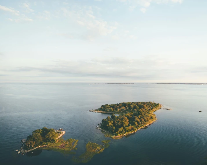 an island in the middle of a body of water, pexels contest winner, rhode island, oland, wide high angle view, slight haze