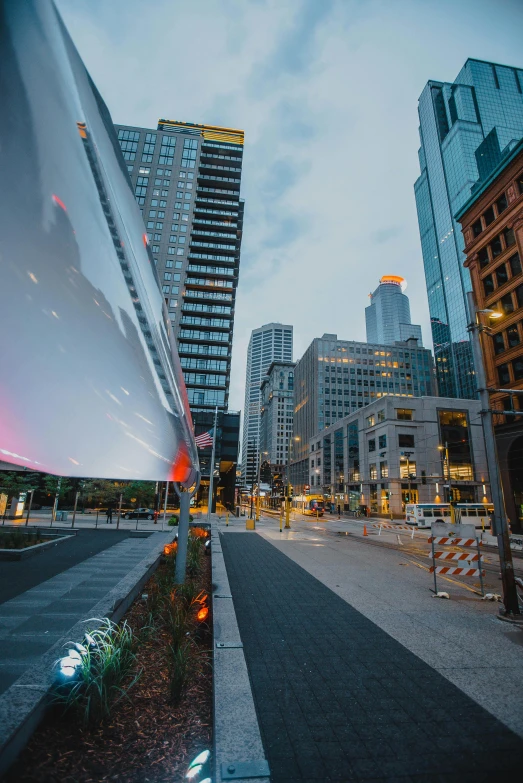 a city street filled with lots of tall buildings, a picture, by William Berra, unsplash contest winner, minneapolis, morphosis, public art, late summer evening