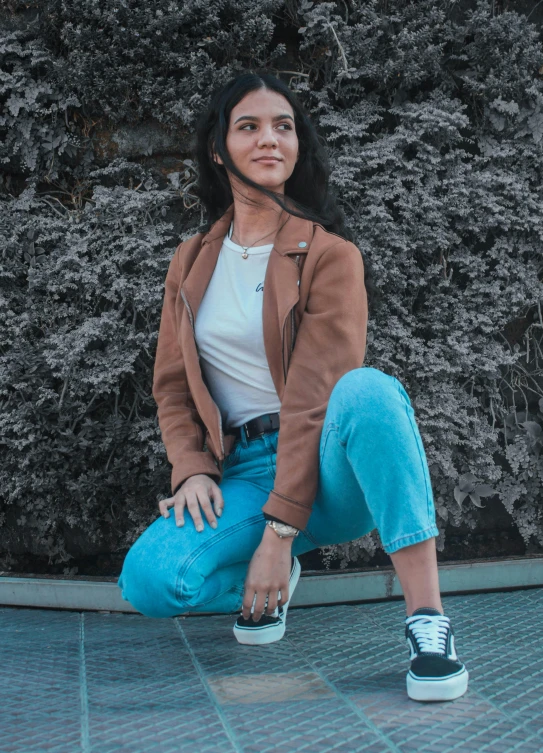 a woman sitting on the ground with a skateboard, pexels contest winner, short brown leather jacket, avatar image, ( ( ( wearing jeans ) ) ), wearing adidas clothing