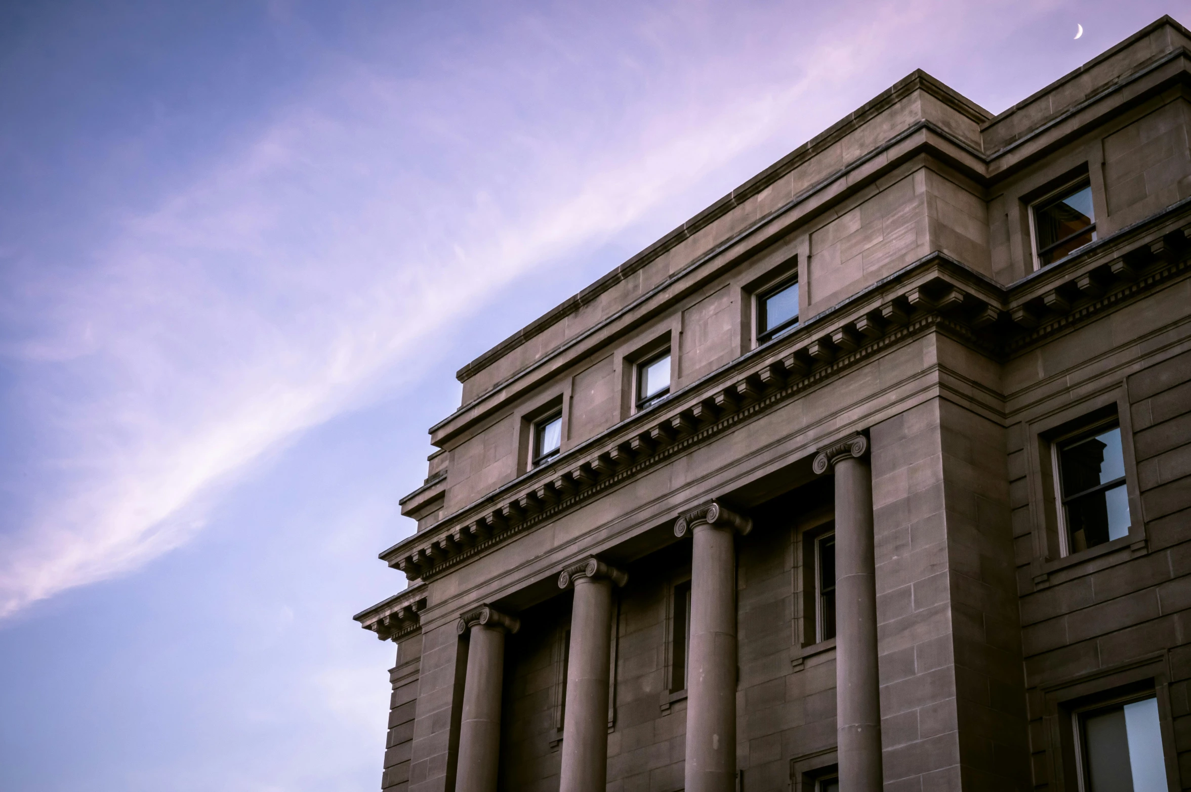 a building with a clock on the front of it, inspired by Rachel Whiteread, unsplash, neoclassicism, concrete pillars, evening light, library, background image